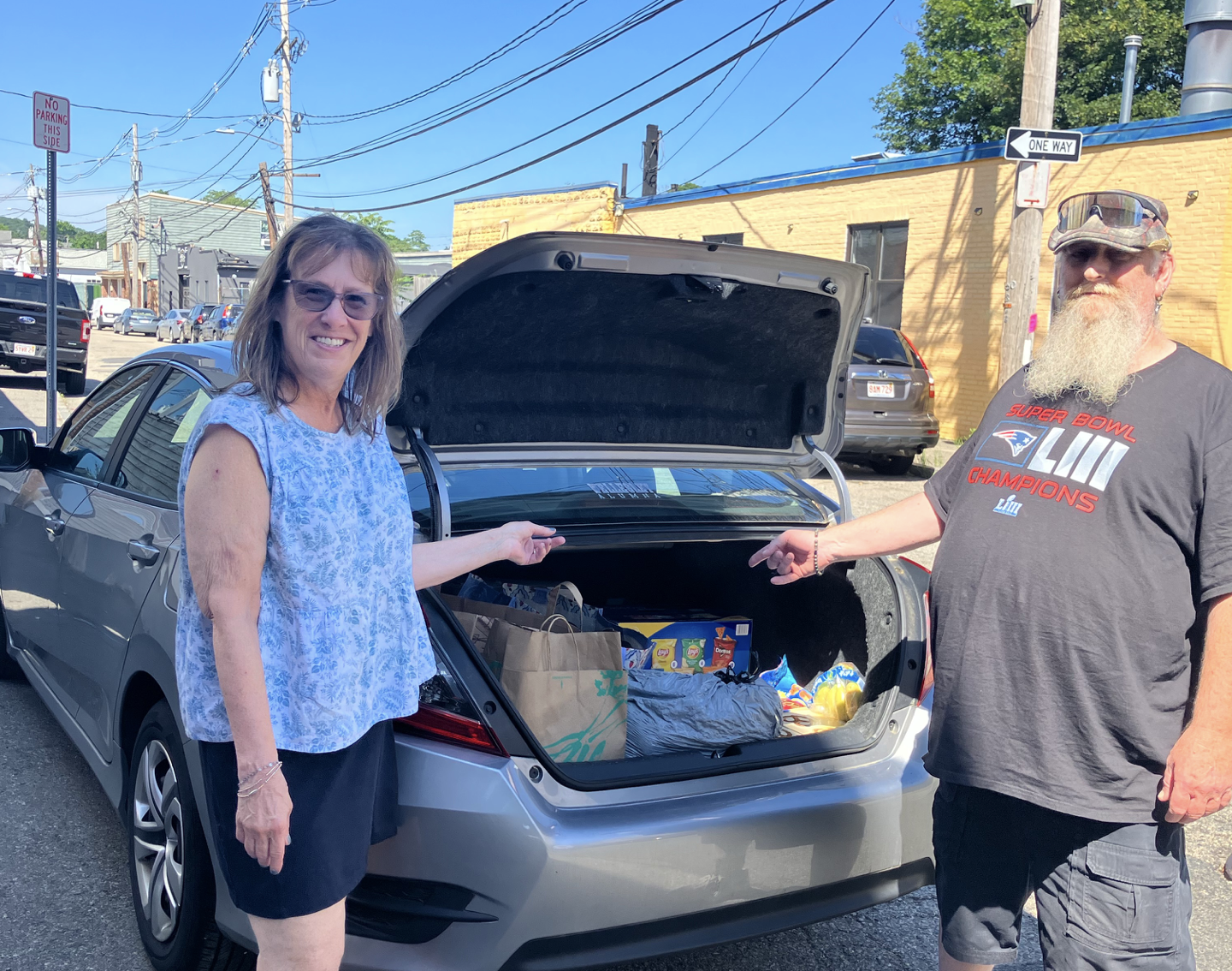 Wendy Donnell with car trunk open, showing sandwich delivery
